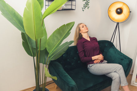 Taking time for rest beautiful caucasian girl enjoying room atmosphere. High quality photoの写真素材