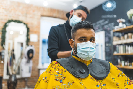 Two men wearing protective face masks at barbershop. High quality photo