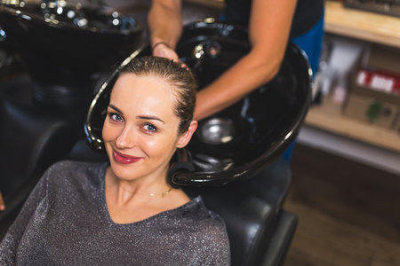 A woman having her hair washed at beauty salon. High quality photoの写真素材