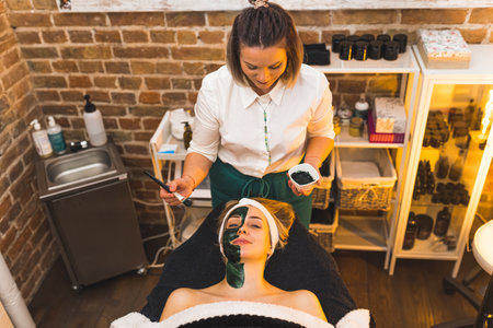 Mud facial skin treatment for a woman at a spa beauty salon. High quality photoの写真素材