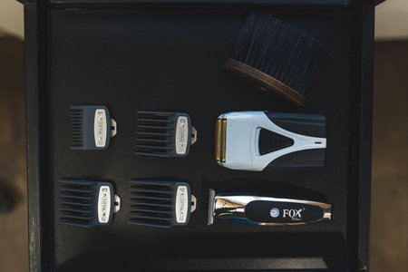 12.02.2022 Warsaw, Poland. Professional barber and hairstyling shaving kit on a shelf. High angle shot. Indoor view. High quality photoのeditorial素材