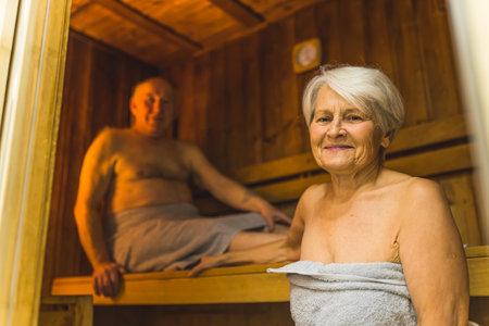 Senior man and woman relaxing in the wooden spa sauna. High quality photoの写真素材