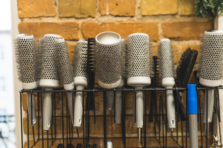 Set of different hair brushes and combs on the wall at the barbershop. High quality photoの写真素材