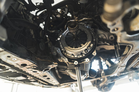 Removing and installation of a new clutch kit for a car in an auto repair shop. High-quality photo