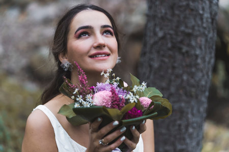Portrait of an young Turkish Bride in a park by the tree. High quality photoの写真素材
