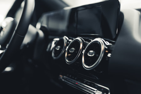 Minimalistic interior of a modern car. Black and gray details in a car cockpit. Inside of a luxury...