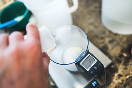 Mixing ice cream ingredients and measuring them with a kitchen scale. High quality photoの写真素材