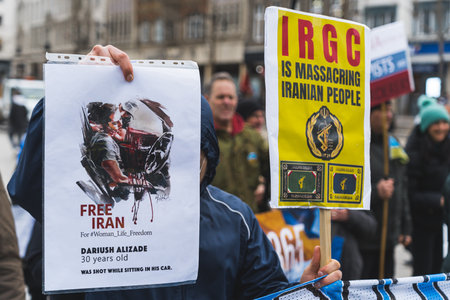 02.28.2023 - Nottingham, United Kingdom - people holding banners to support Iran. High quality photoのeditorial素材