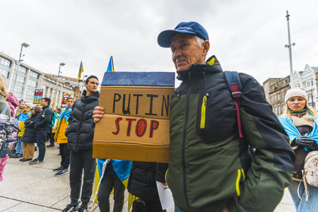 02.28.2023 - Nottingham, United Kingdom - senior man holding a banner saying Putin stop at the...