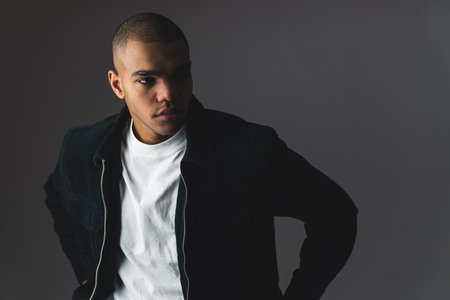 Portrait of an young handsome confident mixed ethnicity model posing in the studio. High quality photoの写真素材