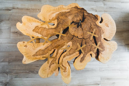top-down shot of a gorgeous textured handmade wooden table in the living room. High quality photo