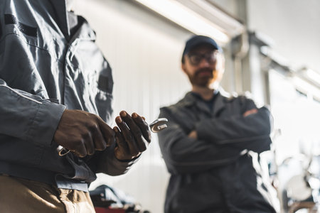 A car mechanic arms holding a wrench. High quality photoの写真素材