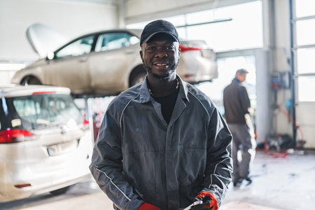 Happy African American man car mechanic in repair service shop. High quality photoの写真素材