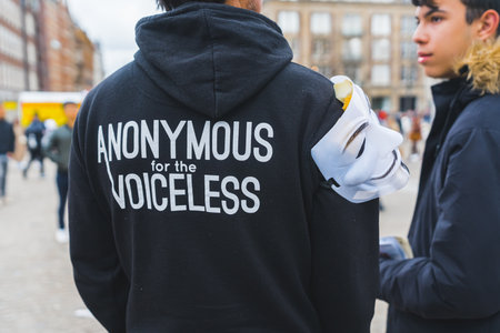 04.18.2023 Amsterdam, Netherlands. Protest on the streets of Amsterdam - anonymous for the voiceless - written on black hoodie of a young protester. High quality photoのeditorial素材