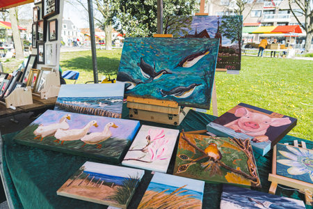 04.18.2023 Hillegom, Netherlands. Paintings with animals and nature sold by Dutch artist at a Hillegom market. Outdoor activities in the Netherlands. High quality photoのeditorial素材