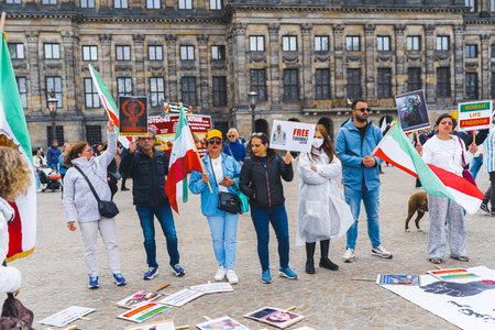 04.18.2023 Amsterdam, Netherlands. Anti-Iranian protest in Amsterdam. Protesters with Iranian flags fighting for equality and freedom of Iranian women. High quality photoのeditorial素材