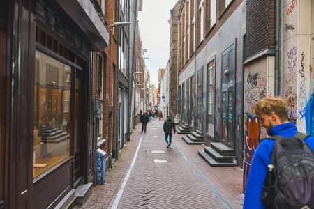02.26.2023 Amsterdam, Netherlands. One of the Amsterdams lane with beautiful Dutch Baroque architecture and pavements. European travelling destinations. High quality photoのeditorial素材