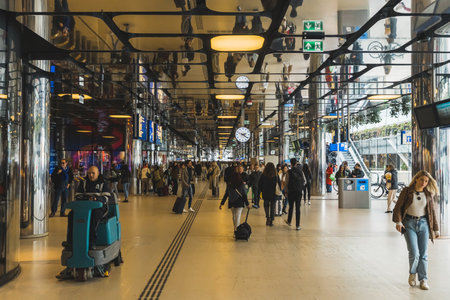 04.18.2023 Amsterdam, Netherlands. Amsterdam Central Station - Amsterdam Centraal - as the largest railway station seen from indoor perspective. Travelling concept. High quality photoのeditorial素材