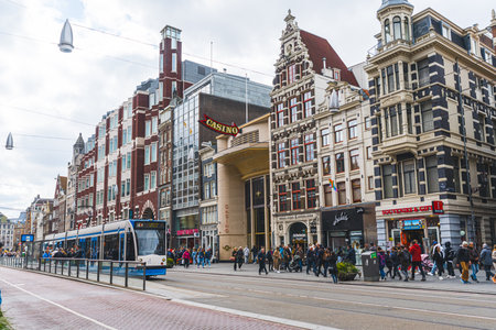 04.18.2023 Amsterdam, Netherlands. Tram station in the centre of Amsterdam. Beautiful architecture of the Netherlands. High quality photoのeditorial素材