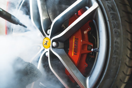 05.17.2023 Warsaw, Poland. Closeup shot of Steam Cleaning Car Rims and Wheels of Ferrari. Professional cleaning process at car detailing studio. High quality photoのeditorial素材