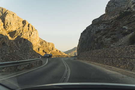 driving on a road surrounded by huge rocks in Kurtaliotika Gorge, Crete, Greece. High quality photoの写真素材