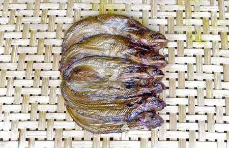 dried fish on shallow bamboo basketの写真素材
