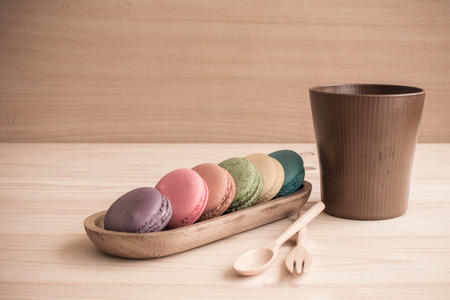 Macarons on wooden table and vintage color toneの写真素材