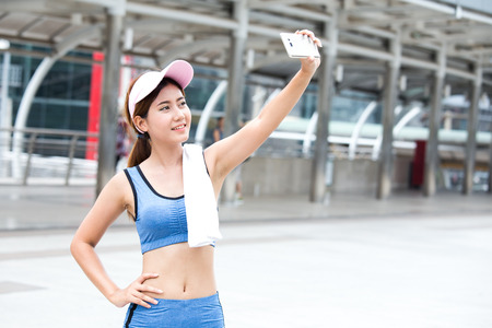 Asain sport woman use smartphone for selfie with attractive smileing, Woman exercise concept.の写真素材