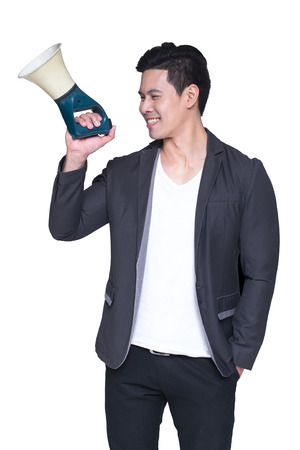 Young asian handsome businessman with magaphone in hands, isolated on white backgroundの写真素材