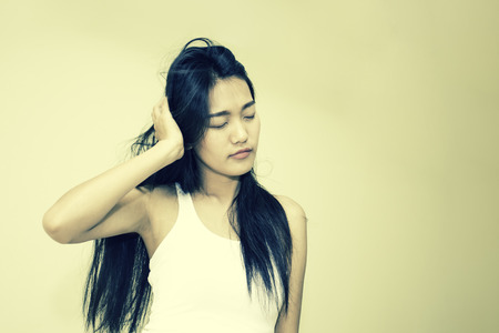 Sleepy asian beautiful woman is wake up in the morning, vintage color tone.の写真素材
