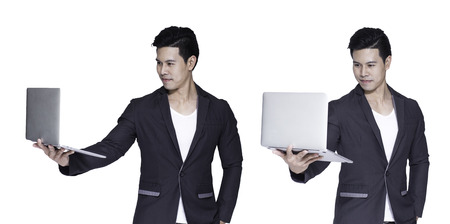 Young asian handsome businessman with computer in hands, isolated on white backgroundの写真素材