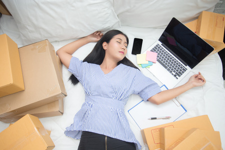Young asian woman business owner sleep on bed at home, woman business owner concept, 20-25 year old.