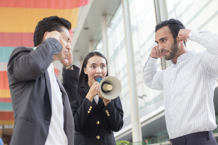 Woman leader with suit posing with megaphone at outdoor place, Businesswoman agreement concept, 20-30 year old.の写真素材