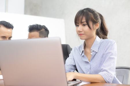 Young woman using laptop for work at modern place, Business people working in modern office. Greeting deal conceptの写真素材