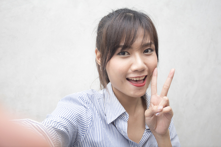 Beautiful young asian woman using smartphone for selfie, 20s year old.の写真素材
