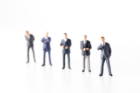 miniature model group of investor standing together isolated on white background.の写真素材
