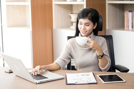 Beautiful young asian woman working at office with happy emotion, woman working concept, 20-30 years old.の写真素材