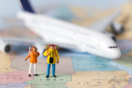 Miniature model couple traveller model standing together on map, people travel in concept,の写真素材