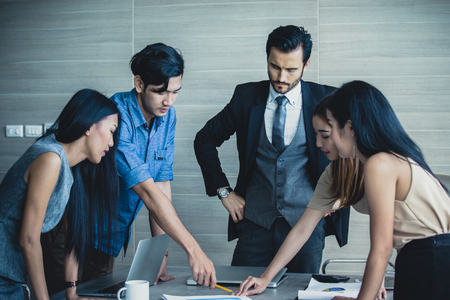 Young Business people working together with serious emotion. Business people takling in modern office. business people working conceptの写真素材