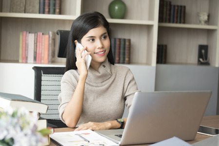 Beautiful young asian woman working at office with happy emotion, woman working concept, 20-30 years old.の写真素材