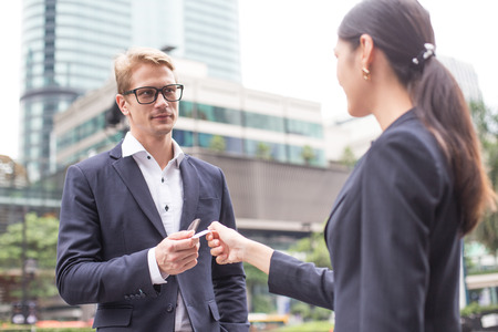 Businessman receive card from Woman. Man working concept.の写真素材