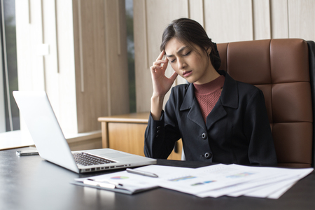 Asian woman working  hard and feeling dizzy at office, woman with office syndrome concept.の写真素材