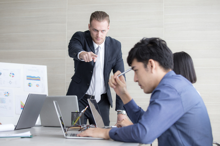 Young Business people working together with serious emotion. Business people takling in modern office. business people working conceptの写真素材