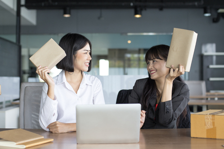 Young Asian Woman holding box with smiling together, Young Owner Woman Start up for Business Online, SME, Delivery Project, Woman with Online Business or SME Concept.の写真素材