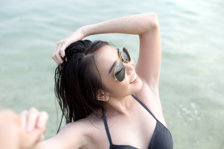 Woman holding Man hand at Sea, People with Summer Conceot, Woman with attractive smiling at beach.の写真素材