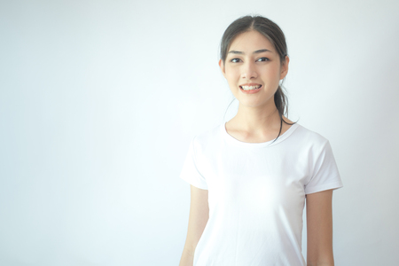 Portrait of Attractive Asian Woman smiling on white background.の写真素材