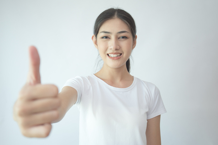 Portrait of Attractive Asian Woman show her hand with smiling on white background.の写真素材