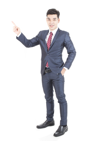 Asian Businessman Point to Direction for Business Plan, Man stand and smile, isolated on white background, Business vision concept.の写真素材