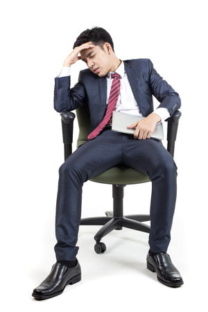 Businessman sitting with serious emotion on white background, Businessman with Technology Concept.の写真素材