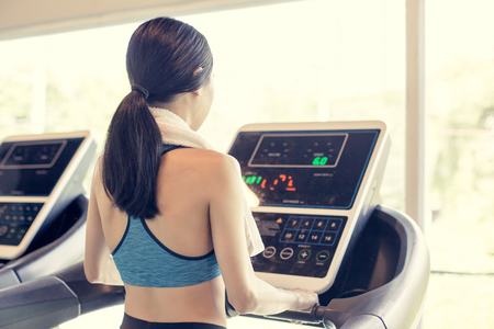 Back of Asian Woman on exercise at a gym. Woman exercise  Concept. Vintage tone.の写真素材